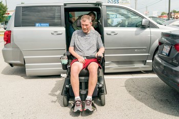 Person living with ALS getting out of car