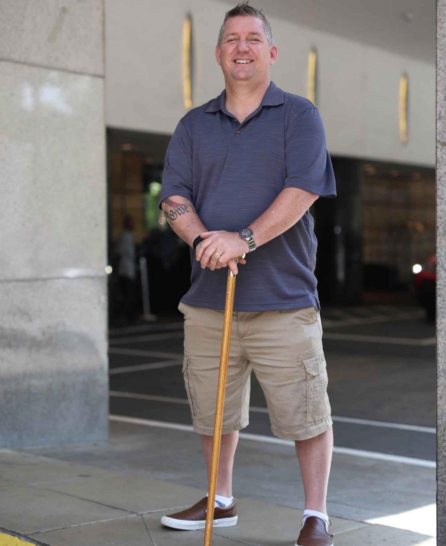 Smiling man with cane