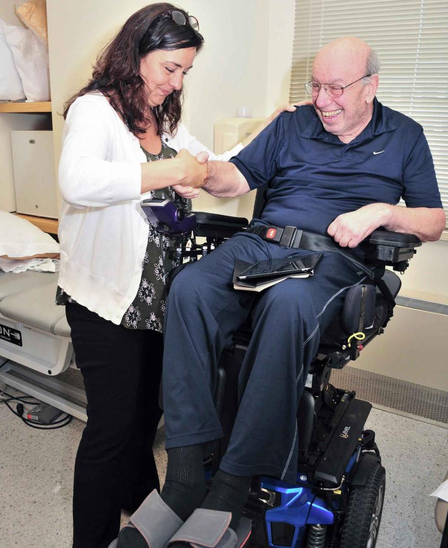 man in wheelchair receiving care from doctor