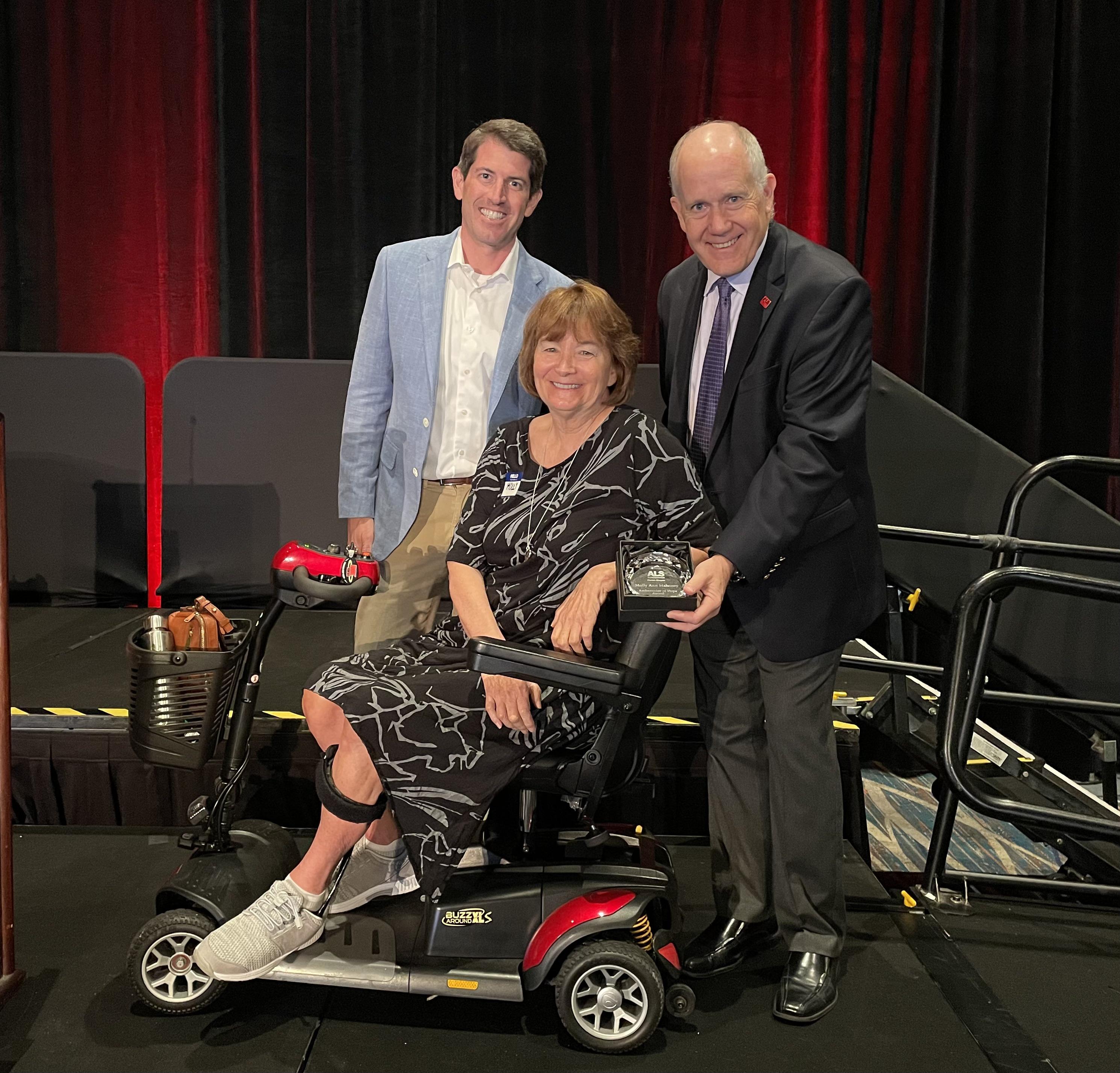 Hampton Graham, ALS of Florida Board Chair (left) and Ray Carson, ALS of Florida CEO (right) present Molly Mahoney with the Ambassador of Hope award. 