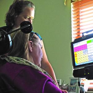Person living with ALS using assistive technology